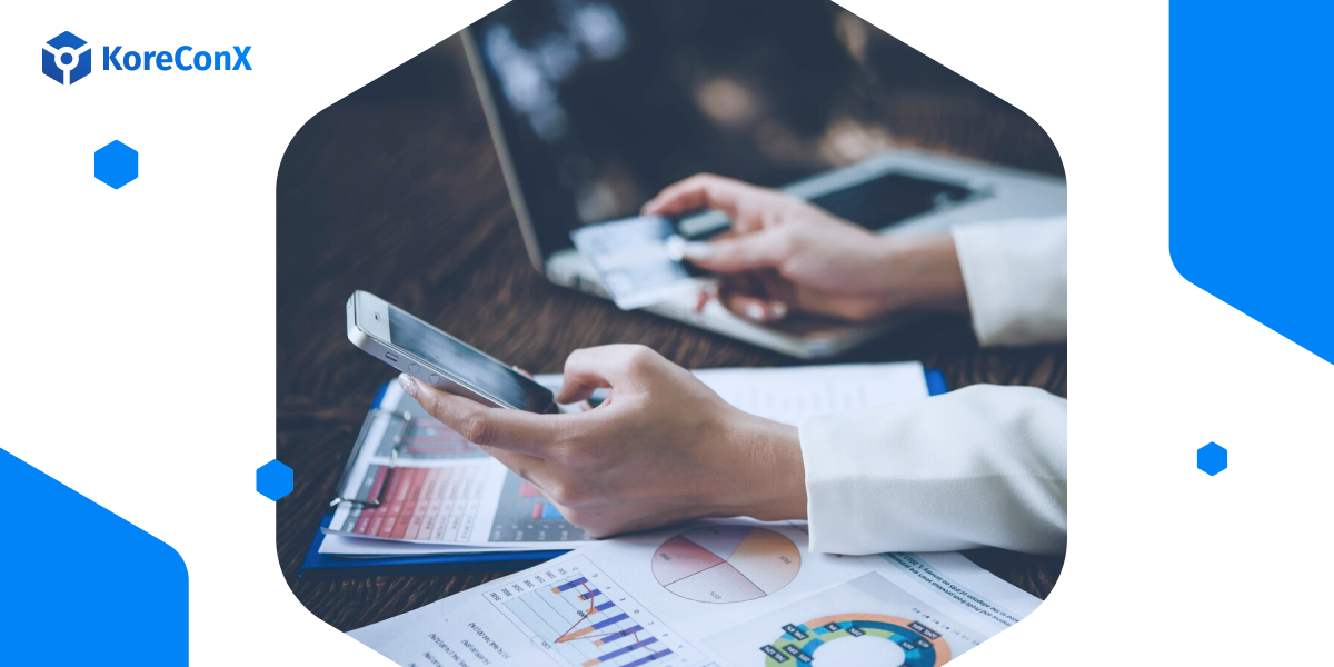 a person holding a mobile device reviewing documents